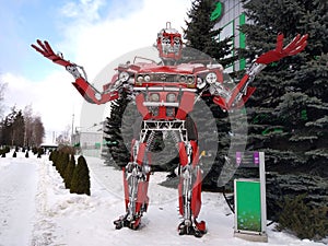 The humanoid metal funny robot the autoboat Red, is made of car spare parts, refuels gasoline, parts of body of the robot,