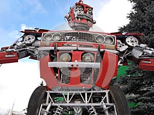 The humanoid metal funny robot the autoboat Red, is made of car spare parts, refuels gasoline, parts of body of the robot,