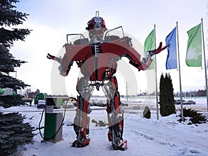 The humanoid metal funny robot the autoboat Red, is made of car spare parts, refuels gasoline, parts of body of the robot,