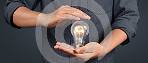 Humans hold light bulbs in hand innovative technology and creativity