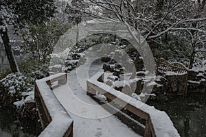 Humble Administrator`s Garden bridge in snow, ancient suzhou, china