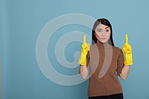 Humble confidence asian houseworker pointing fingers upward