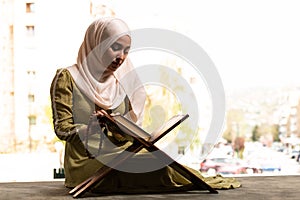 Humble Muslim Woman is Praying With Quran