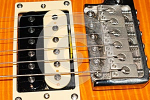 Humbucker pickup on a PRS SE Santana electric guitar in yellow product shot