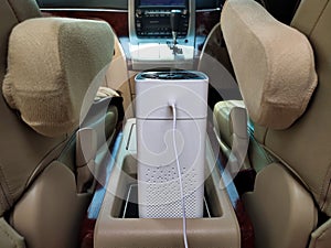 Humidifier and air freshener while driving. White humidifier hydrates dry air. Increase comfort in the car. photo