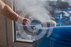 Humidifier producing a vapor with a baby`s hand