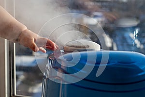 Humidifier producing a vapor with a baby`s hand