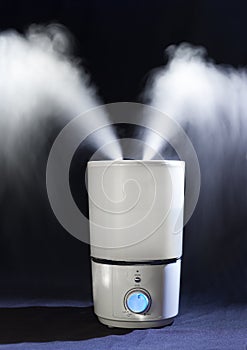 Humidifier spreading steam in darkness