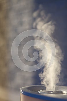 Humidifier spreading steam with white brick background