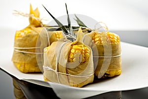 Humita, steamed wrapped corn cakes. AI generative photo