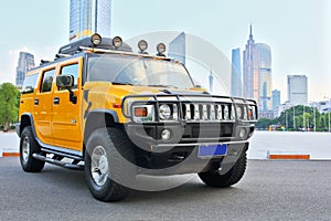 A hummer H2 ORV in Guangzhou skyline background