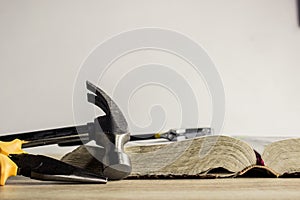 Hummer with tools and Bible on a table photo