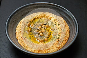 Hummus appetizer in a stone bowl