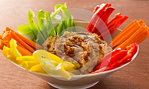 Hummus bowl with bell peppers and carrots sticks