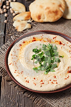 Hummus in bowl with pita traditional arabic