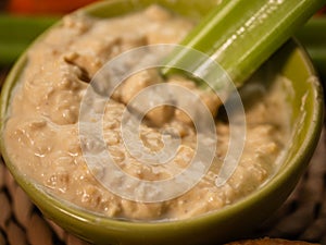 Hummus and celery dips in a bowl