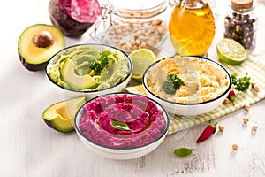 Hummus, colorful different dips, vegan snack, beetroot and avocado hummus, vegetarian eating