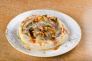 Hummus is a dip, spread, or savory dish made from cooked, mashed chickpeas