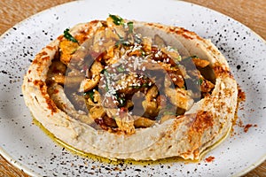 Hummus is a dip, spread, or savory dish made from cooked, mashed chickpeas