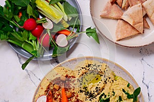 Hummus with fresh crispy vegetables. top view