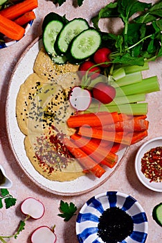 Hummus with fresh crispy vegetables. top view