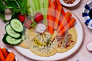 Hummus with fresh crispy vegetables. top view