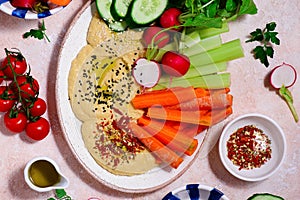 Hummus with fresh crispy vegetables. top view