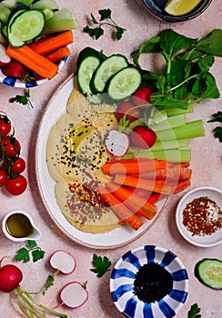 Hummus with fresh crispy vegetables. top view