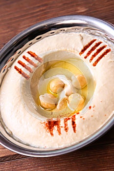 Hummus or hummos served in dish isolated on background top of arabic food cold mezza photo