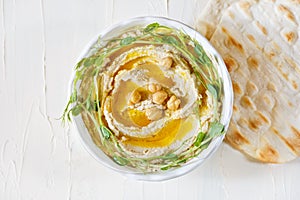 Hummus with olive oil and sprouts