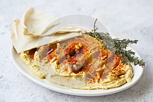 Hummus with paprika, pine seeds and lebanese bread pita, healthy vegetarian oriental chickpea dish, homemade hummus