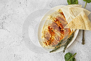 Hummus with paprika, pine seeds and lebanese bread pita, healthy vegetarian oriental chickpea dish, homemade  hummus