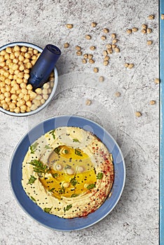 Hummus topped with whole chickpeas, olive oil and paprika