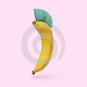 Humor is a cheerful banana with a mohawk hairstyle on a pink background.