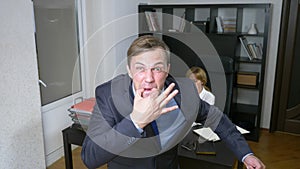 Humor, irony. a man in the office whistles, alerting workers. business concept.