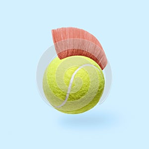 Humor pop art fun tennis ball with a pink mohawk hairstyle.