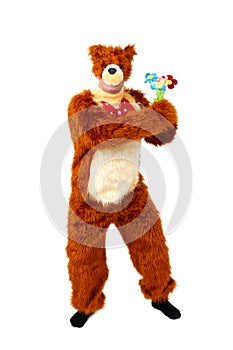 Humorous bear with toy flowers on white background