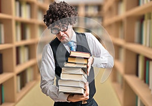 Humorous nerd professor with many books in library photo