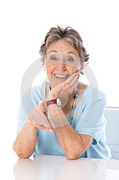 Humorous older lady pointing - elder woman isolated on white background