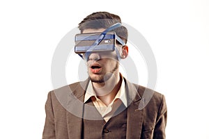 A humorous photo of modern technologies. Young guy with a phone attached to the head using a tape. Virtual reality gadget