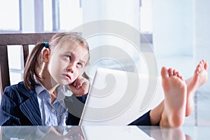 Humorous photo of sad child business girl is working in the office. Horizontal image. Copy space