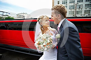 Humorous picture bride and groom on red limo