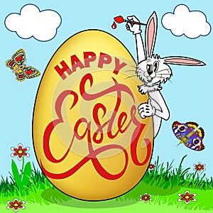 humorous picture on Easter. Rabbit paints an egg with a greeting in a clearing with butterflies