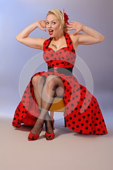 Humorous pinup girl in red dress with tattoo