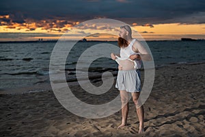 Humorous portrait of a brutal man posing on the beach at sunset