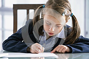 Humorous portrait of young business girl  calculates monthly peofit, income and expenses. Horizontal image