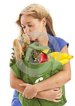 Humorous portrait of young woman kissing food photo