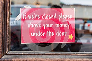 Humorous sign in a storefront window in the Texas hill country