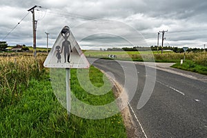 Humorous weathered danger road sign warning of possible UFO in Scotland