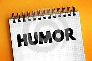 Humour - the quality of being amusing or comic, especially as expressed in literature or speech, text concept on notepad